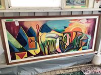 Full view of the large framed abstract painting showing colorful geometric and natural shapes, signed by Maurice Wharton.