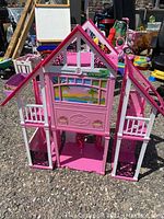 Front view of Barbie Chalet playhouse showing pink and white colors, open front, balconies and detailed decals