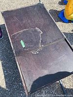 Top view of dark wood coffee table with visible wear and extendable top panel.