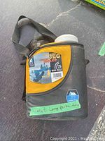 Black and yellow Arctic Zone insulated cooler with carrying strap and attached tag showing one gallon jug.