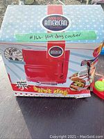 Photo of the original boxed hot dog cooker showing brand and product identity.