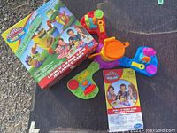 Overview of Play-Doh Launch-O-Rama Game including box, play platform, and game pieces.