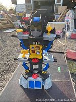 Front and top view of Batman toy showing colors and interactive parts