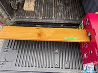 Top view of a rectangular pine shelf with a smooth flat surface and attached back edge, showing natural wood grain and finish.