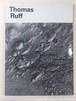 Front cover of a Thomas Ruff art catalog with black and white lunar surface image