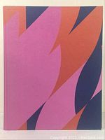 Front cover of the hardcover art book featuring geometric abstract artwork in purple, orange, and navy blue.