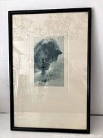 Front view of the framed print showing the animal image and surrounding white matting with reflections visible on glass.