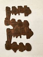 Photo showing the full vintage metal printer block with Christmas design on a white background.