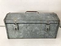 Galvanized metal rectangular tin box closed, showing overall condition and latches