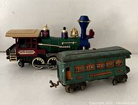 Two vintage toy train cars displayed side by side showing condition and details.