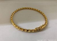 Image showing the bracelet in a slightly oval shape with the twisted rope design and clasp visible.