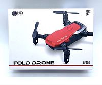 Red Fold Drone LF606 box front with HD Camera logo and age recommendation 14+. Shows the drone image in red color folded with four propellers.