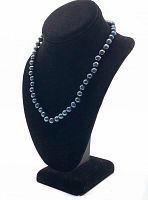 Black pearl necklace displayed on black bust stand against white background, showing full length of the necklace and the natural luster and color variation of pearls.