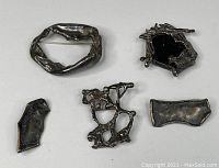 Overhead view showing all five pieces laid out, displaying the set's variety in shapes and open/solid designs.