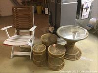 Overview of white plastic chair, wooden table, wicker tables