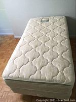 Full view of mattress on box spring and frame