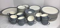 Overall view of plates, cups and bowls arranged on white background