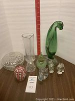 View showing assortment of glass items including vase, candy dish, eggs and figurines