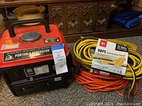 Generator and three extension cords on carpeted floor