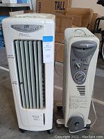 Front view of SPT evaporative cooler and Peconic heater side by side showing control panels and vents.