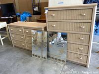 Image showing the wicker look dresser and chest of drawers placed on concrete floor with mirror and picture set in front