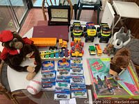 Full overhead view of all toys included in the lot on glass table by window.