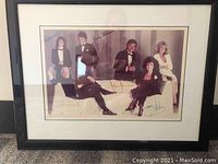 Framed signed photograph of six Dynasty cast members in formal wear with autographs across the image.