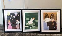 Three framed animated art posters arranged in a row showing a dancing couple with lanterns, girl on lily pads, and character with owl.