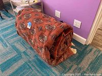 Rug rolled on floor showing overall roll and pile density