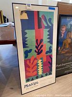 Full front view of Matisse 'The Cut-Outs' framed poster showing colorful abstract design and title text underneath
