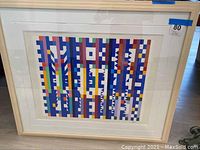 Frontal view of entire framed lithograph showing colorful geometric pattern with mat and frame.