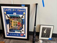 Overview of framed poster, baseball bat, small framed print, and autographed baseball