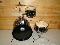 Full view of Evans kids drum set showing bass drum, mounted tom, snare drum, and cymbal stand