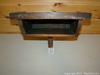 Front view of vintage wooden wall-mounted shelf showing flat top and open storage space beneath