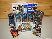 Photo showing the entire Star Trek memorabilia lot including VHS tapes, figures, toys, and promotional items with good to excellent condition.