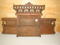 Full view of the wooden mantle piece showing overall size and missing decorative parts.