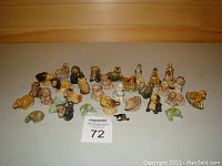 Overview of all about 35 Wade ceramic figurines representing wildlife, dogs, nursery rhyme characters. Various colors with glossy finish.