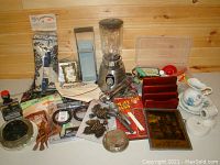 Full overview of the grab lot showing various items including blender, tools, decorative objects, and sewing supplies.