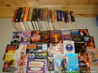 Photo showing front covers and spines of a variety of fiction and mystery novels, mostly paperback