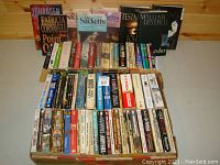 First photo showing full lot of Western and other books arranged in two rows with spines and covers visible