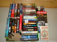Top view of the entire collection of James Patterson books arranged on a surface, showing titles and colorful book spines.