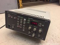 Front angled view of Phillips PM 5515 Colour TV pattern generator showing digital displays, function buttons, and dials on black front panel