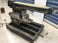 Overall view of Eaton Tecomaster radial arm saw on its base without stand