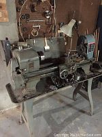 Full view of lathe and stand with accessories on bed tray