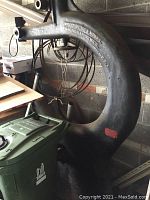 Full view of large one-piece cast iron bandsaw body with embossed West-Side Iron Works maker's mark and partial view of surrounding items