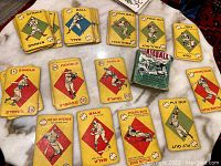 Layout of vintage baseball game cards showing various baseball play actions with colored diamond background.