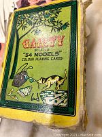 Photo of the green and yellow box with Gaiety Brand 54 Models label and cat illustration.
