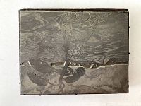 Top view of the rectangular metal printer block showing the etched detailed design inspired by Group of Seven artwork.