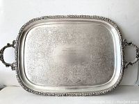 Front view of the large vintage silver plate serving tray with the full tray and ornate handles visible