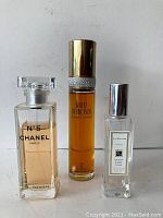 Front view of three perfume bottles: Chanel No 5 Eau Premiere, White Diamonds Eau de Toilette, and Jo Malone London Cologne.